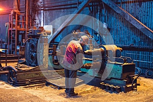 Heavy Industry Worker Working Hard on Machine. Rough Industrial Environment