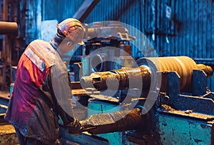 Heavy Industry Worker Working Hard on Machine. Rough Industrial Environment