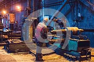 Heavy Industry Worker Working Hard on Machine. Rough Industrial Environment