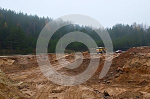 Heavy large quarry dump truck. Big wheels. The work of construction equipment in the mining industry. Production useful minerals.