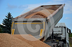 heavy load car. dump a load of gravel into a large pile.