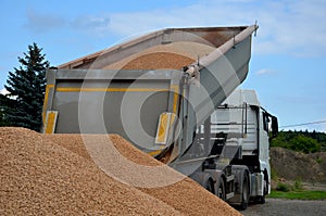 heavy load car. dump a load of gravel into a large pile.