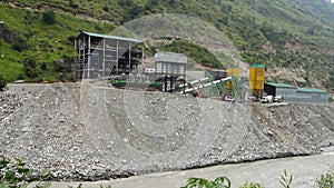 Heavy machinery at a Hydro Electric Power Project on River Satluj , causing river bank erosion. River devastation scene