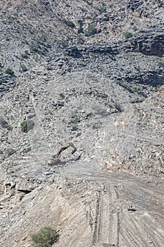 Heavy machinery in the process of mountain road construction works in Saudi Arabia