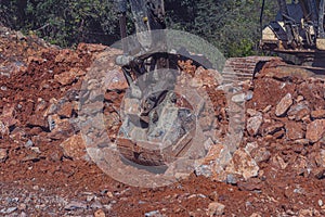 Heavy machinery works at the construction site. Clearing rocky soil for construction in Turkey