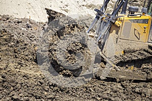 Heavy metal blades of Bulldozer move mounds of dirt