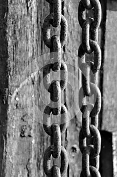 Heavy metal chains on a weathered wooden pole