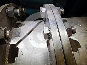 Heavy metal chrome flange, with large screws and bolts and washers