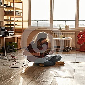 Heavy metal musician play electric guitar at home