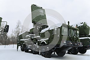 Heavy military equipment of Russian armed forces against the background of a winter forest