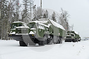 Heavy military equipment of Russian armed forces against the background of a winter forest