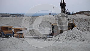 Heavy Mining Dump Truck Being Loaded With Iron Ore in pit