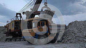 Heavy Mining Dump Truck Being Loaded With Iron Ore in pit