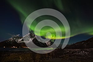 Heavy northern lights activity above Mt. Stornappstinden in Flakstad island, Lofoten