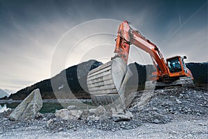 Heavy organge excavator with shovel