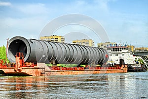 Heavy oversized chemical apparatus is transported by river transport through the shipping channel on a special barge