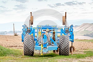 heavy plow and cultivator standing on a field in Tuscany, agriculture and machinery concept