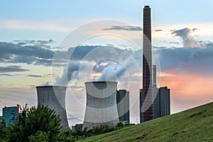 Heavy power plant industry, chimney and towers with pollution at the HKM steelworks in Duisburg, Germany against a cloudy sky at