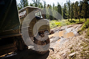 Heavy powerful truck-terrain vehicle with off-road wheels