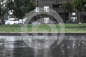 Heavy rain, close-up of splashing and flying drops with an inver