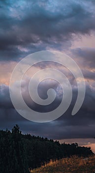 Heavy rain clouds in the deep blue sky before the rain at the summer day
