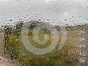 heavy rain drops on the window and screen