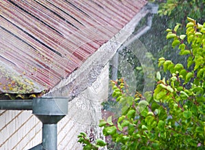 Heavy rain. Rainwater pouring out of old downspout