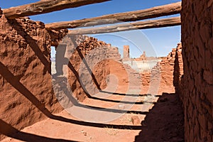 Heavy roof beams, shadows, and window of small mission at Abo Ruins, New Mexico.