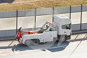 Heavy semi tow big rig truck tractor driving on city highway