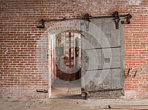 Heavy sliding metal industrial door in old warehouse