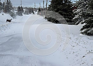 Heavy snow drifts on a rural residential road