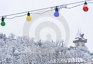 Heavy snow and the famous clock tower on Schlossberg hill, in Graz, Steiermark region, Austria. Selective focus