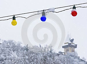 Heavy snow and the famous clock tower on Schlossberg hill, in Graz, Steiermark region, Austria. Selective focus