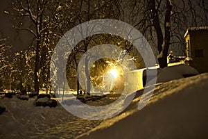 Heavy snow in park with lamp light