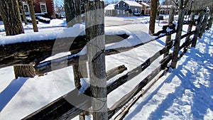 Heavy snow in wooden fence. Victorian homes in Canada.