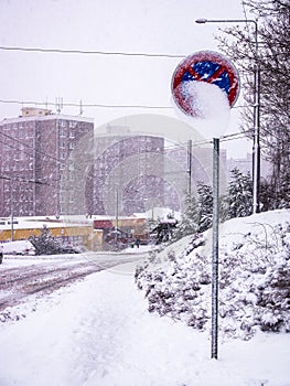 Heavy snowfall in the city - Traffic signno stoppinghalf-covered with snow