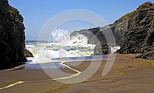 Heavy surf waves breaking on secluded black lava sand beach between rocks  - Cobquecura Piedra De La Loberia, Chile, Pacific coast photo