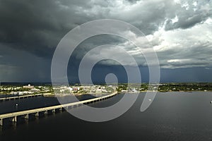 Heavy thunderstorm approaching traffic bridge connecting Punta Gorda and Port Charlotte over Peace River. Bad weather photo