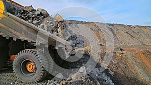 Heavy tipper truck on the quarry unloads earth