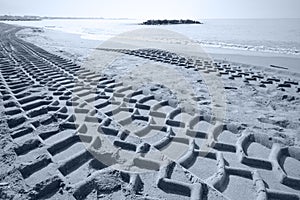 Heavy tire tracks in the sand