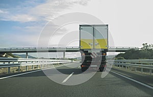 Heavy tow truck carrying semi-trailer truck on freeway