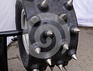 Heavy tractor tire with big metal spikes on it