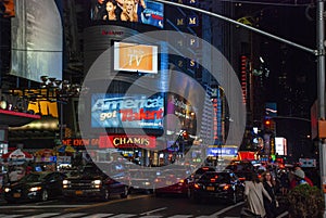 Heavy traffic and illuminated billboard ads at night at Times Square, New York City