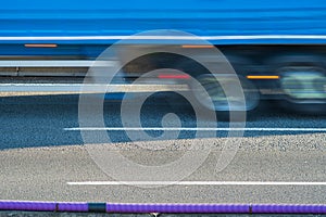 heavy traffic moving at speed on UK motorway in England at sunset