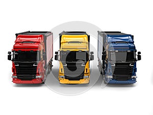 Heavy transport trucks - red, blue and yellow - front view