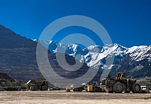 Heavy Truck And Bulldozer At Open Cast Ore Mine