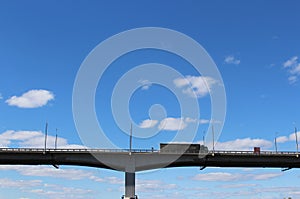 A heavy truck is driving along a transport bridge