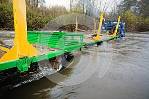Heavy truck for transportation of logs stuck in the river