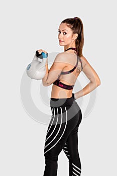 Heavy weight in hands of woman isolated on white background. Sport, fitness, bodybuilding, training, lifestyle . Image