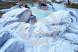 Heavy winter frost on creek-side rocks